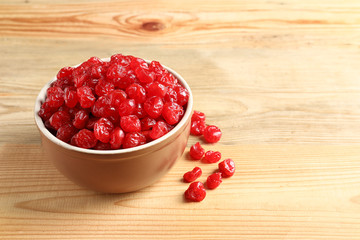 Bowl of sweet cherries on wooden background, space for text. Dried fruit as healthy snack