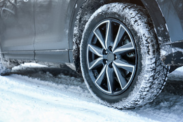 Snowy country road with car on winter day, closeup