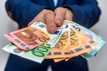 Selective focus of euro banknotes in male hands