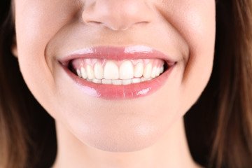 Young smiling woman with healthy teeth, closeup