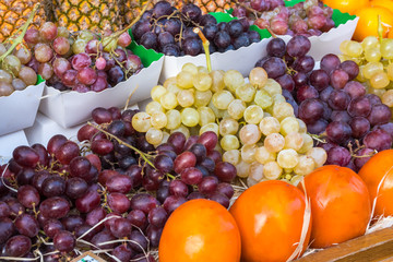 Red grapes and various fruits in the market