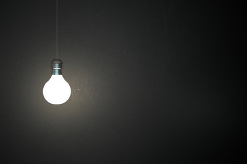Glowing lamp on concrete wall