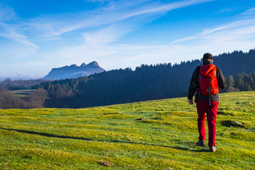 Tourist with a backpack walking in the natural park of Aiako-Harriak to mountains in the Basque Country