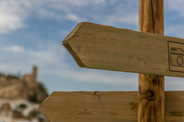 Wooden markers with an old town in the background