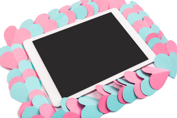 Tablet computer framed with paper hearts isolated on white background. Tablet pc with blank screen