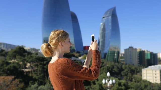 young woman taking pictures on the city of Baku