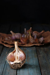 raw garlic on wooden background, rustic style