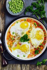 Delicious Shakshuka on the wooden background. Healthy eggs breakfast 