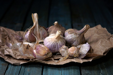 raw garlic on wooden background, rustic style