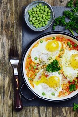 Delicious Shakshuka on the wooden background. Healthy eggs breakfast 