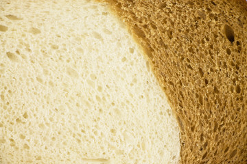 Closeup of structure of white and brown loaf.