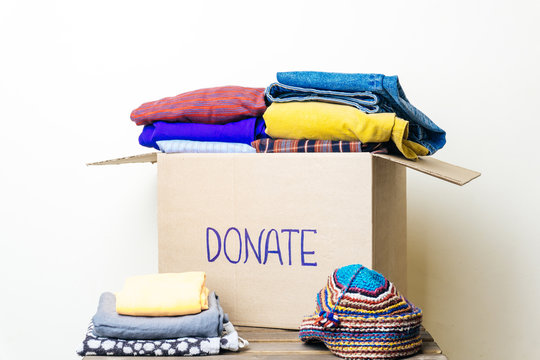 CLOTHES DONATION AND FOOD DONATION CONCEPT. Donation box with clothes and hygiene products.