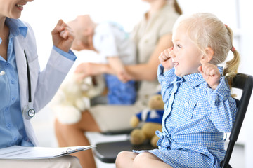 Doctor and a little blonde girl. Usual health exam. Medicine and healthcare concept