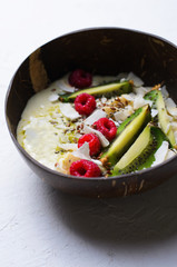 Smoothie Bowl Topped with Raspberry, Kiwi, Chia, Flaxseed and Coconut