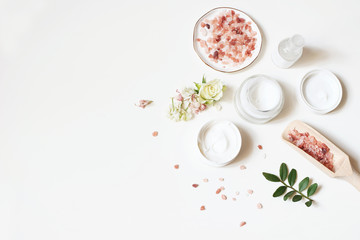 Styled beauty composition. Skin cream, tonicum bottle, dry flowers, rose and Himalayan salt on...