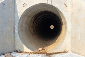 Fototapeta na wymiar Drainage, sewer pipes, concrete pipes, leading water under the road