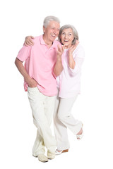 portrait of senior couple hugging on white background