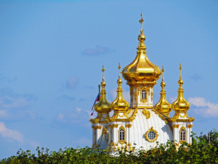 Fototapeta na wymiar The Golden dome of the Church against the blue sky with clouds