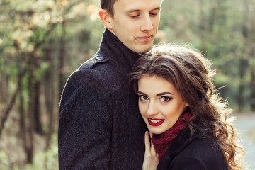 Young happy couple in love hugging outdoors. Tender, romantic, relationships concept