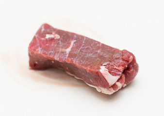 slices of raw meat on a white background