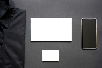Fototapeta premium Casino chips, black shirt, business card, envelope and mobile phone.