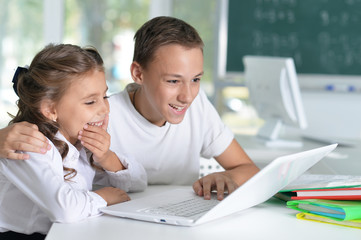 Portrait of brother and sister doing homework