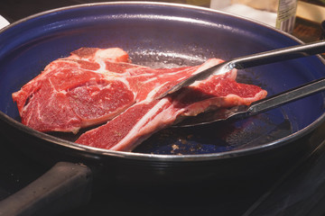 Veil steak being cooked in frying pan/
