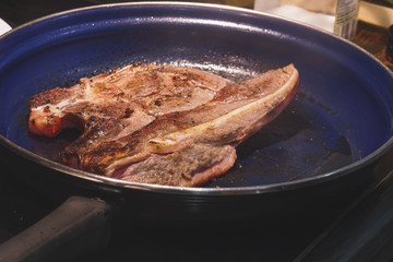 Veil steak being cooked in frying pan/