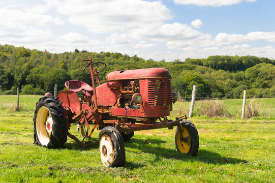 Vintage red tractor in landscape