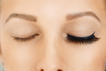 Female eyes with long false eyelashes, befor and after effect. Eyelash extensions, make-up,...