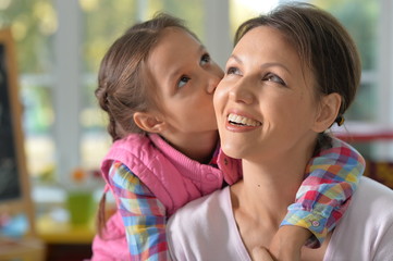 portrait of a charming little girl with mom 