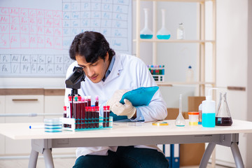 Young chemist working in the lab 