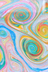 Fluid art from different colors. Multicolored background from paints on liquid. Bright pattern on liquid. Colored paint stains in style of pop art