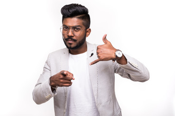 Call me back please. Young attractive hipster indian man, makes phone sign, indicates with index...