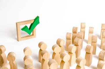 A crowd of people looks at a green check mark. Voting and election concept. Referendum, revolution....