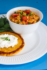 Traditional colombian breakfast huevos pericos with corn cakes