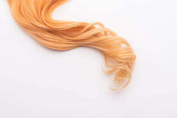 Human, natural honey-colored blond hair on white isolated background. Stylish, fashionable colors...