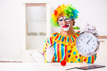 Male clown preparing for perfomance at home 