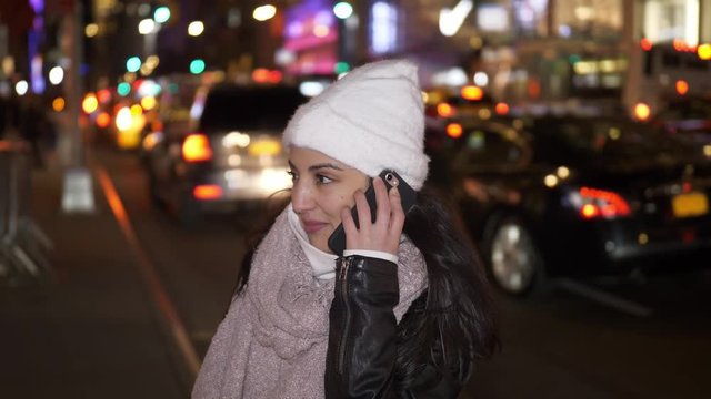 Young woman takes a phone call in the streets of New York
