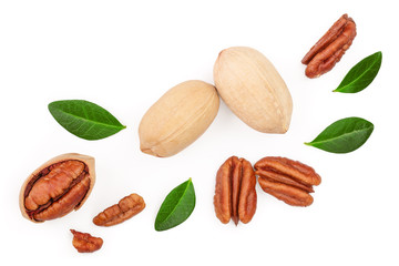pecan nut decorated with green leaves isolated on white background. Top view. Flat lay
