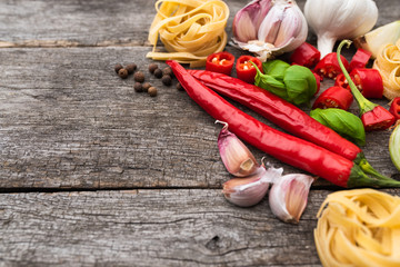 Composition with popular ingredients used in Italian dishes on old, natural boards. Fresh additives...