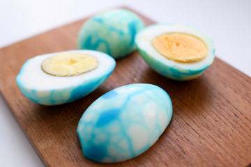 Easter eggs are peeled white with blue and turquoise veins and yellow yolks