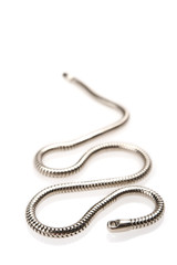 Silver chain on white background. Focus on foreground.