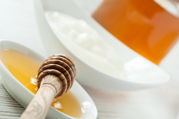 Fototapeta na wymiar Fresh honey and milk yogurt in porcelain tableware