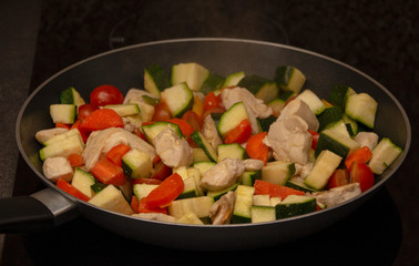 vegetables with meat on a griddle, close-up, healthy food