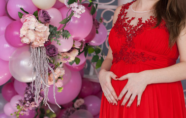 Pregnant woman in red expecting a baby.