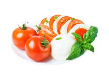  Сaprese salad with ripe tomatoes and mozzarella cheese with fresh basil leaves. Italian food. 