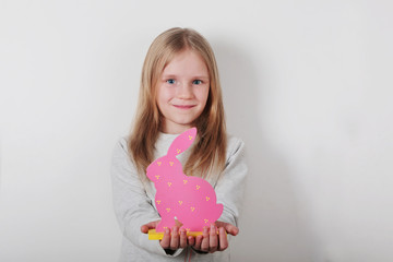 Beautiful little blond girl with Easter rabbit  on white background