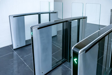 Turnstiles. Checkpoint. Automatic access control. Access system in the building. Automatic turnstile with sliding doors to control the flow of people. Entrance hall with turnstile