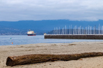 Pier in Vancouver, with mountains and cargo ship on the background